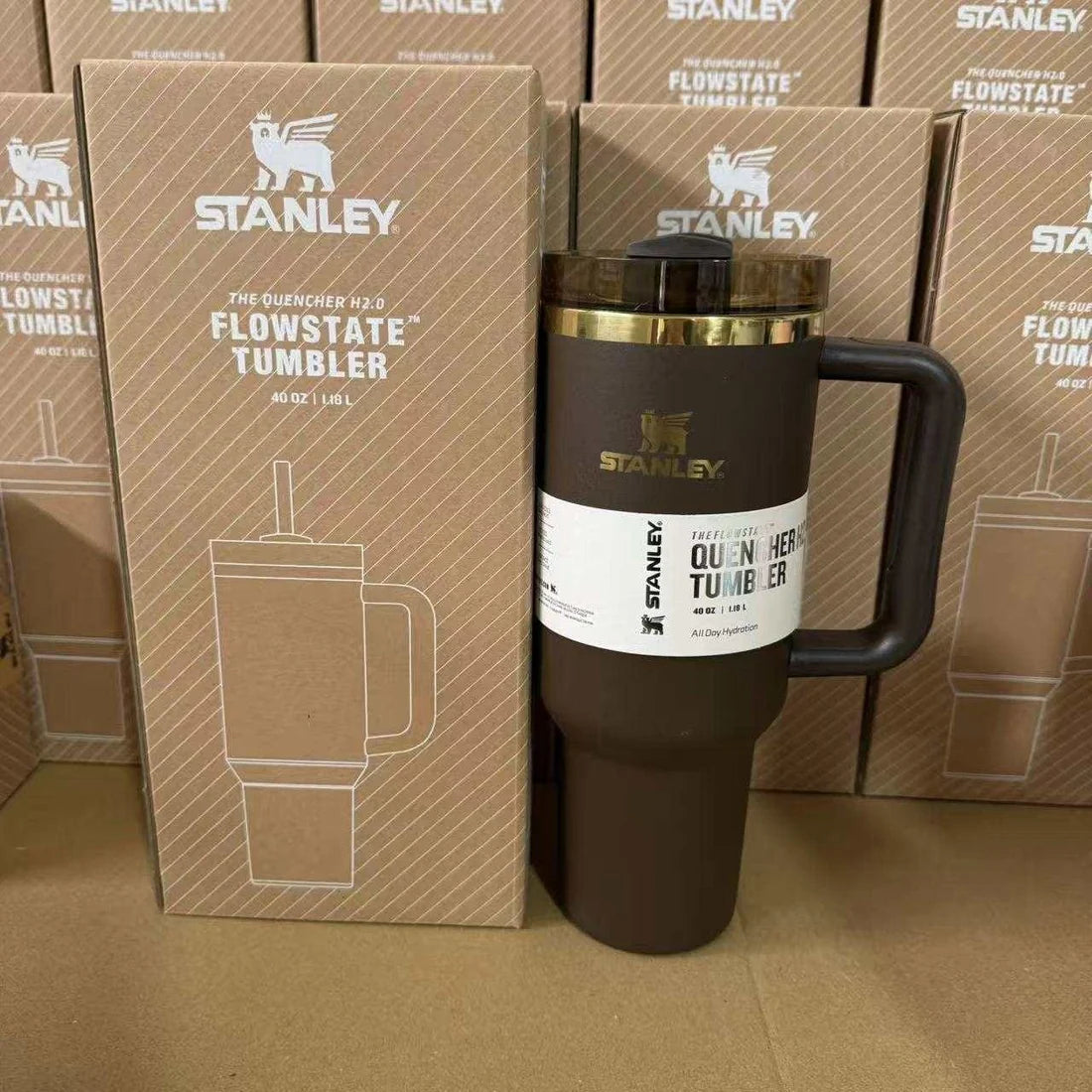 Stanley Flowstate tumbler with packaging in front of stacked Stanley boxes.