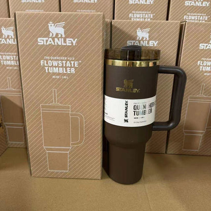Stanley Flowstate tumbler with packaging in front of stacked Stanley boxes.